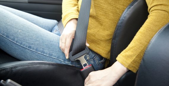 Person putting on seat belt